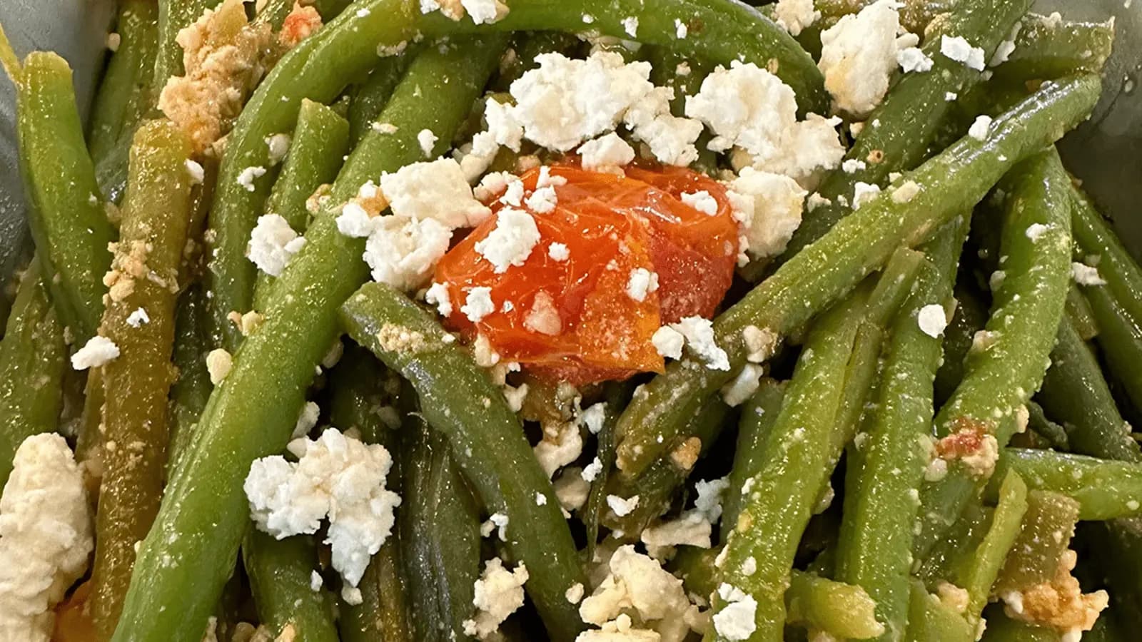 Fresh green beans topped with crumbled feta cheese and a balsamic dressing.