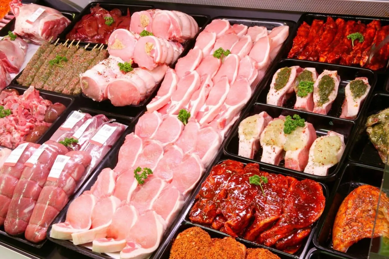 The Rise Of Sustainable Meat In Atlanta | Frazie'S Meat &Amp; Market Display of various cuts of sustainably sourced meat, including pork chops, marinated ribs, and skewers, emphasizing freshness and quality at Frazie's Meat & Market.