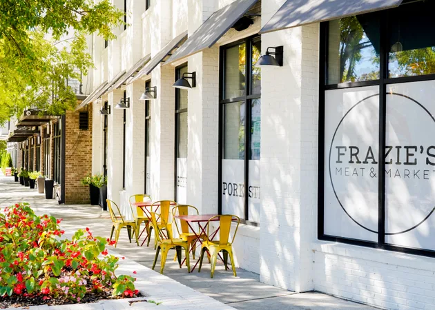 The Frazie's Meat & Market storefront on Main Street NW, with pavement tables and planting outside the window.